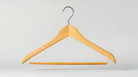 A beautifully crafted wooden hanger, neatly holding clothes, against a soft neutral backdrop, ideal for showcasing wardrobe essentials or decor elements.の素材
