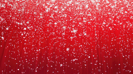 A bright red holiday backdrop with snowflakes floating down, ideal for adding text or creating festive promotions, cards, and holiday designs.の素材