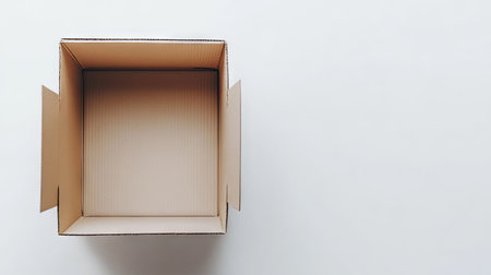 A clean, open cardboard box with visible interior flaps on a white background, perfect for illustrating moving or storage purposes in photographyの素材