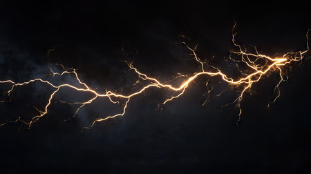 Dynamic lightning bolt with branching extensions, isolated on a black backdrop, highlighting the force and beauty of natural electrical phenomena.の素材