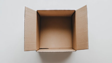 Top view of a closed cardboard box with a simple, clean design on a white background, ideal for minimalist packaging, shipping, or storage visualsの素材