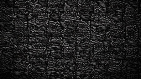 This image features a close-up of a dark woven fabric texture, showcasing intricate patterns and depth, perfect for various design and artistic projects.の素材