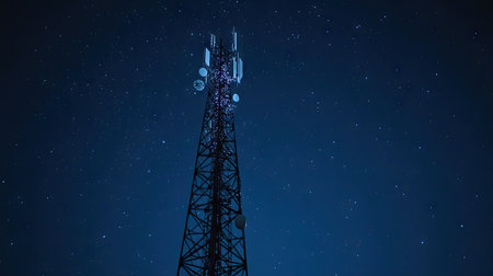 A signal tower with sparkling white lights, shining brightly against a clear night sky.の素材