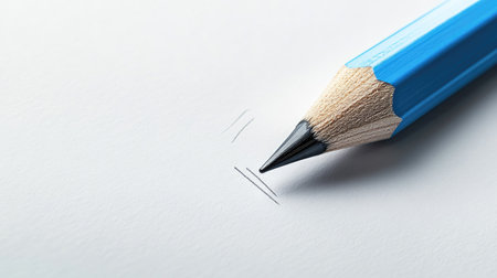 Blue pencil with sharp black lead sketching light lines on a neutral white-gray background. Ideal for creative design, business, and educational content.の素材