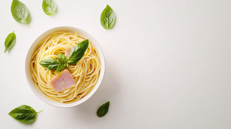 A vibrant bowl of spaghetti featuring tender ham and fresh basil leaves, perfect for a delightful meal. Ideal for food photography and culinary presentations.の素材