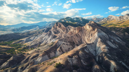 A panoramic view of a rugged mountain range with visible rock strata and geological formations, highlighting the exposed Earth's crust in a natural setting. -の素材