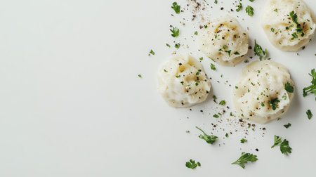 A scrumptious close-up of dumplings garnished with herbs and pepper on a pristine white surface, perfect for showcasing culinary delights and dining experiences.の素材
