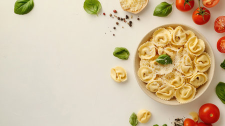 Indulge in a plate of fresh tortellini topped with parmesan and garnished with basil, accompanied by vibrant tomatoes and spices, perfect for any meal.の素材