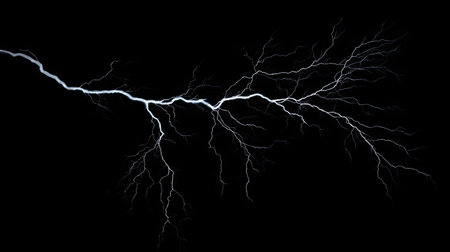 Intense lightning bolt with detailed branches isolated on a black background, showcasing the dramatic impact and force of electrical storms.の素材