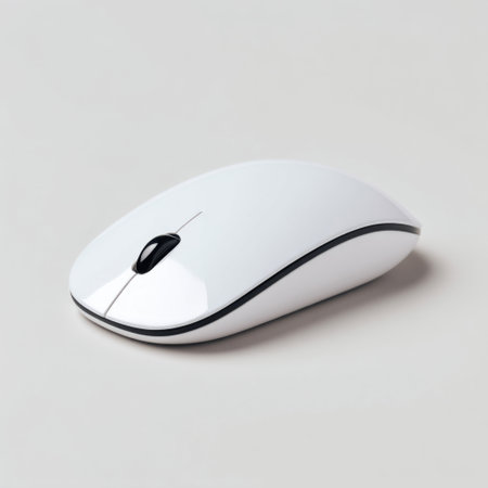 A sleek white wireless computer mouse positioned on a light gray surface, ideal for showcasing modern technology and office accessories.の素材
