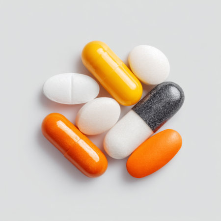 A vibrant assortment of pills and capsules arranged on a grey background, symbolizing treatment, health, and wellness in modern medicine.の素材