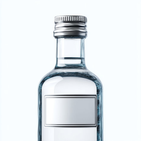 A sleek glass bottle with a silver metal cap is filled with clear water, set against a soft, light background, ideal for product presentations.の素材