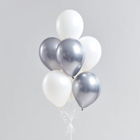 A stunning arrangement of white and silver balloons floating gracefully against a minimalist background. Perfect for celebrations, parties, or elegant events, this image showcases the beauty and simplicity of balloon decorations.の素材