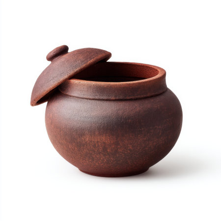 This rustic clay pot with a lid showcases traditional craftsmanship. Perfect for kitchen decor or as a unique storage container. Its earthy tones enhance any setting.の素材