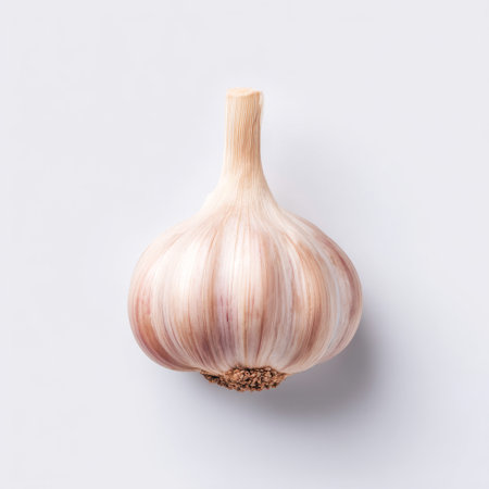 A vibrant fresh garlic bulb displayed against a clean white background. Ideal for culinary photography, showcasing healthy cooking ingredients and flavors.の素材