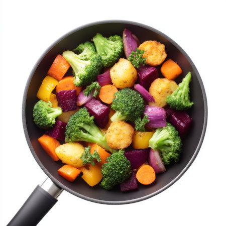 A vibrant mix of colorful fresh vegetables including broccoli, carrots, and purple potatoes, cooking in a non-stick pan, perfect for healthy meal inspiration.の素材