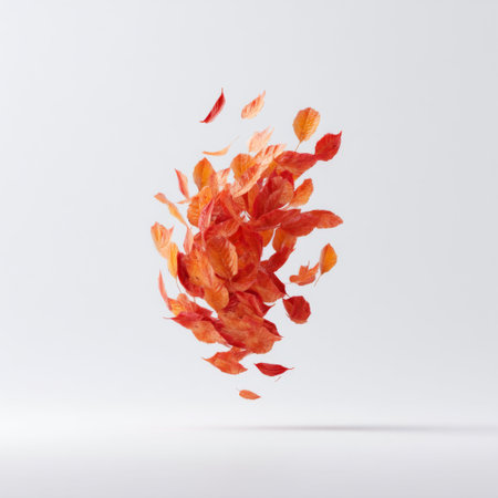 A stunning display of vibrant orange and red autumn leaves gracefully floating against a simple white background, capturing the essence of seasonal change.の素材