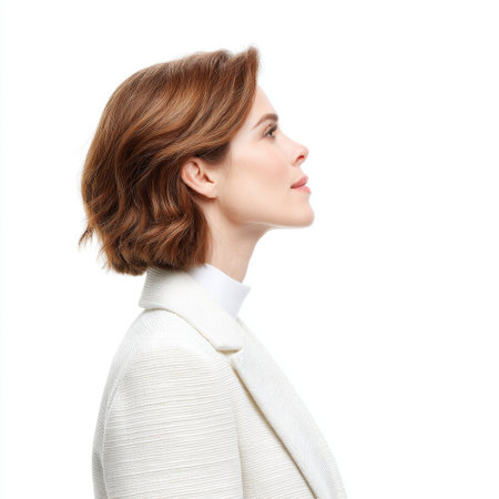 A graceful woman in profile showcases her elegant short brown hair and chic white blazer. The image reflects confidence, beauty, and professionalism.の素材