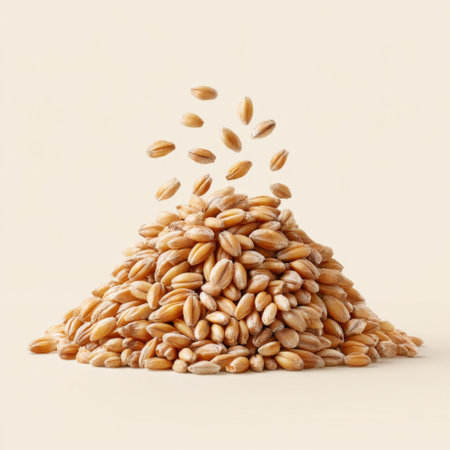 A captivating image showcasing a mound of raw wheat grains with falling seeds, set against a soft beige background. Ideal for agricultural, culinary, and nutrition themes.の素材