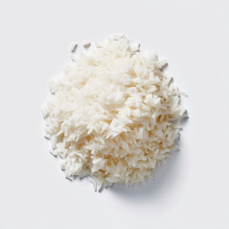 A close-up image of a mound of uncooked white rice against a pristine white background, highlighting its delicate texture and culinary versatility.の素材