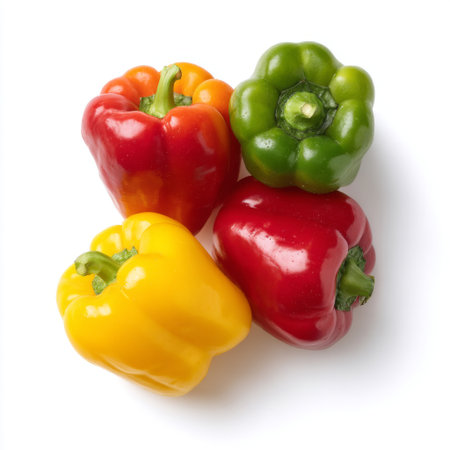 A vibrant assortment of fresh bell peppers, including red, yellow, and green varieties, stacked together against a clean white backdrop, perfect for culinary projects.の素材
