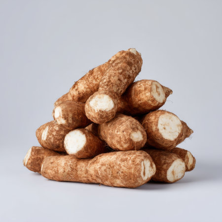 A visually appealing arrangement of fresh cassava roots showcasing their texture and earthy tones, ideal for culinary and dietary applications.の素材