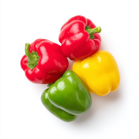A stunning arrangement of vibrant bell peppers showcasing red, yellow, and green colors on a clean white background, perfect for healthy recipe ideas.の素材