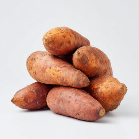 A visually appealing stack of fresh organic sweet potatoes offers a perfect representation of healthy eating and farm-fresh produce. Ideal for culinary use.の素材