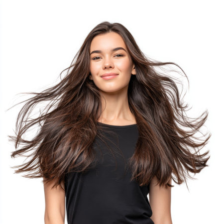 A young woman with long, beautiful hair smiles in a studio environment, exuding confidence and joy. Her natural beauty highlights a relaxed and trendy atmosphere.の素材