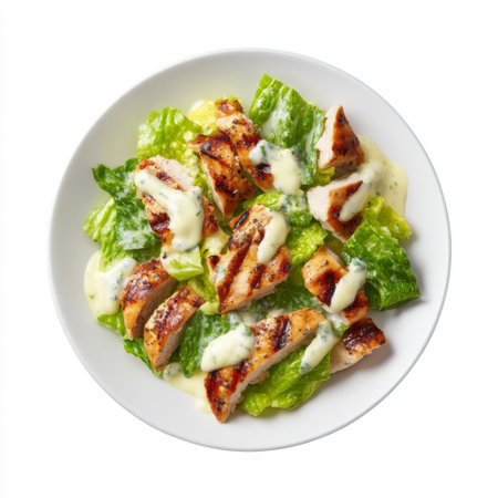 A vibrant grilled chicken salad featuring tender pieces of chicken on a bed of fresh romaine lettuce, drizzled with creamy dressing, ideal for healthy meals.の素材