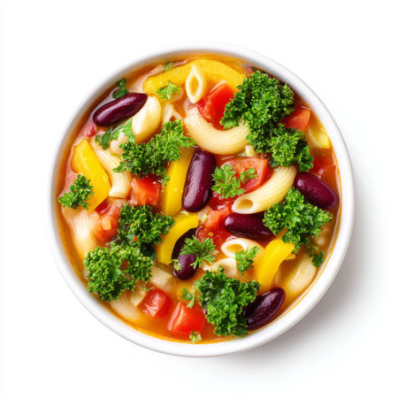 A vibrant bowl of vegetable soup with pasta, showcasing fresh ingredients like tomatoes, beans, and herbs on a clean white background. Perfect for healthy meals.の素材