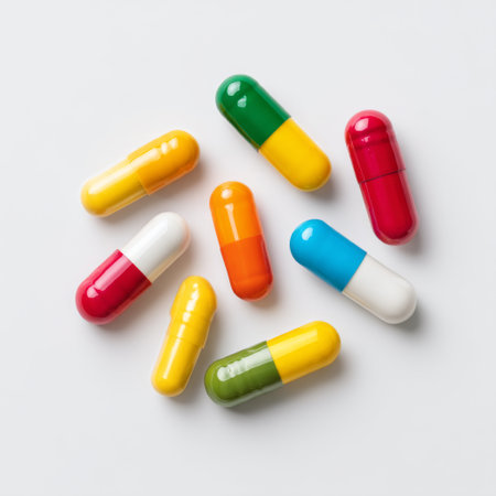 A vibrant assortment of colorful capsules and pills lying on a clean white surface, representing concepts of health, wellness, and medical treatments.の素材