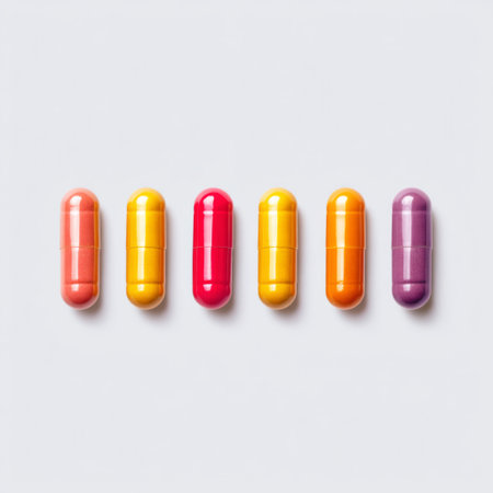 A vibrant arrangement of colorful capsules displayed in a neat line on a clean white background, perfect for health and wellness themes in visual content.の素材
