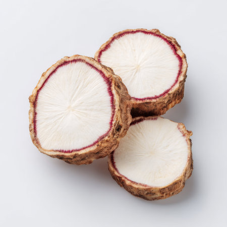 Beautifully sliced root vegetable showcases intricate patterns and textures in a clean, bright setting. Ideal for culinary and health-focused projects.の素材