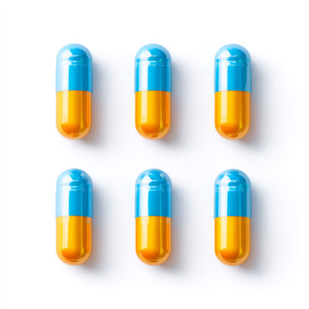 A striking arrangement of colorful capsules with blue tops and orange bottoms set against a clean white background. This image conveys health and wellness themes, making it ideal for use in medical and pharmaceutical contexts.の素材
