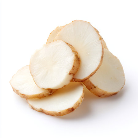 Freshly sliced raw white potato pieces showcase their natural texture, perfect for healthy cooking and meal preparation ideas in any kitchen.の素材
