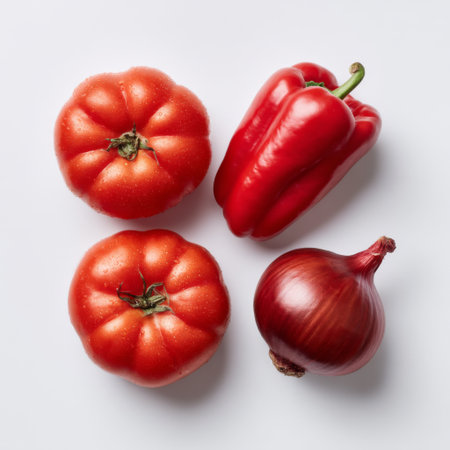 A collection of fresh red tomatoes, a vibrant bell pepper, and an onion arranged on a light background, ideal for promoting healthy cooking and nutrition.の素材