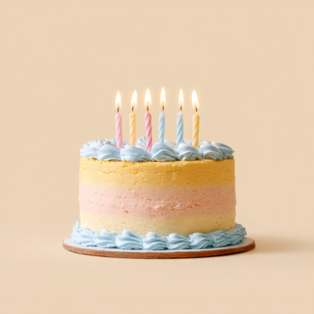 A delightful birthday cake adorned with soft pastel frosting and lit candles, perfect for celebrating special moments with joy and sweetness.の素材