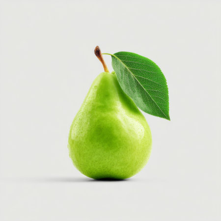 A vibrant green pear with a single leaf sits elegantly against a light background, highlighting its freshness and nutritious qualities, ideal for health-related themes.の素材