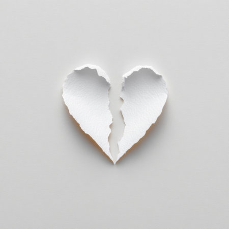 A minimalistic design featuring a torn paper heart shape against a smooth, neutral background, symbolizing emotions of love and heartbreak.の素材
