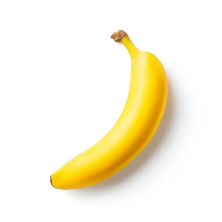 A vibrant yellow banana isolated on a white background, showcasing its smooth texture and natural curves. Ideal for health-focused themes, nutrition discussions, or culinary creativity.の素材