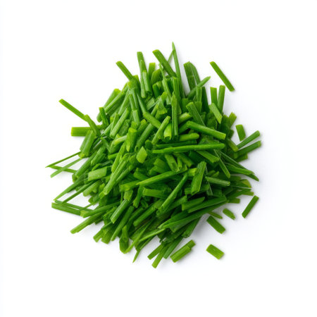 A vibrant pile of freshly cut green chives on a clean white background, perfect for culinary use, garnishing dishes, and enhancing flavors in cooking.の素材