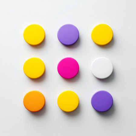 A captivating arrangement of colorful circular shapes in vibrant yellows, pinks, and purples on a clean surface, perfect for modern design needs.の素材