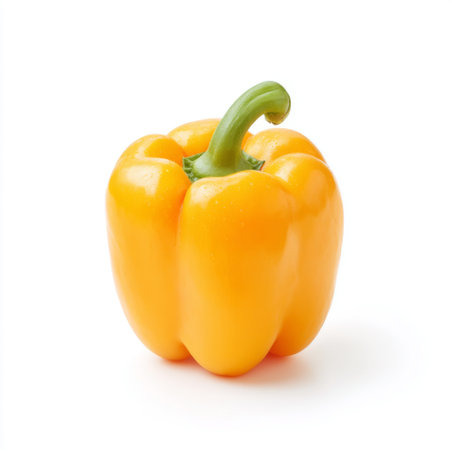 This bright yellow bell pepper stands alone against a clean white background, showcasing its vibrant color and smooth texture, ideal for various dishes.の素材