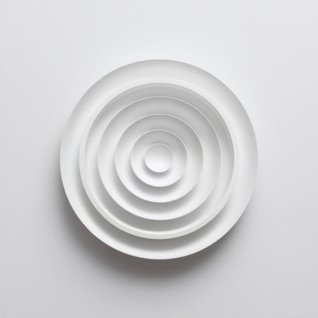 A visually striking arrangement of nested white circular plates creates a sense of depth and elegance. The minimalistic design emphasizes the beauty of simplicity in modern aesthetics.の素材