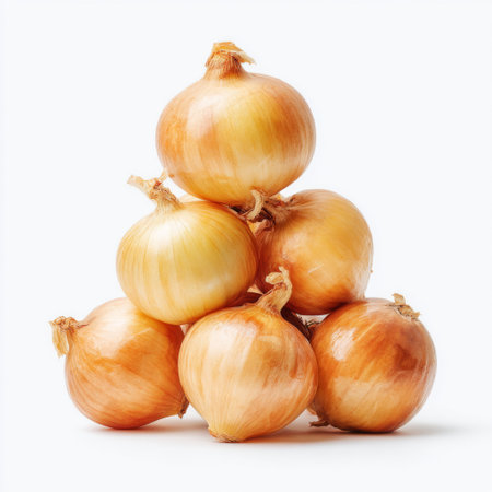 A vibrant arrangement of fresh golden onions stacked in a pyramid shape, ideal for culinary and food-related projects, showcasing natural colors and textures.の素材