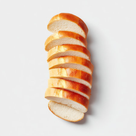 A beautifully sliced loaf of bread with a golden crust, showcasing its soft interior. Perfect for culinary projects, food photography, or bakery advertisements.の素材