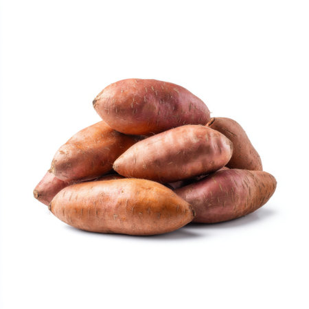This image showcases a pile of freshly harvested sweet potatoes against a pristine white background, ideal for highlighting healthy recipes and nutrition-focused meals.の素材