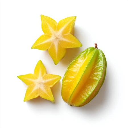 Bright and vibrant starfruit slices alongside a whole fruit showcase the beauty of tropical produce. Ideal for healthy eating concepts and food photography.の素材