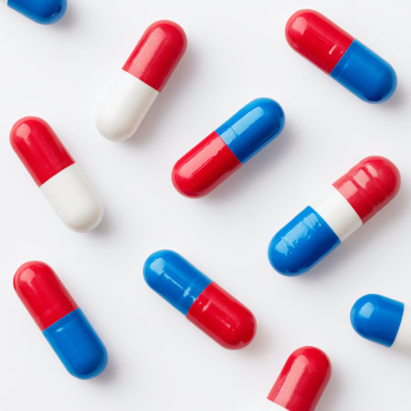 A visually appealing layout of colorful capsules in red, blue, and white on a clean surface, ideal for health, wellness, and pharmaceutical themes.の素材